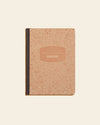 Composition Book in Kraft on a themed background