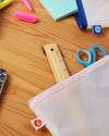A close up image of the Letterfolk 3 Piece Pouch Set with stationery on a wooden table.