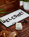 Letterfolk Tile Mat in white on display