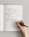 Composition Book in Black on a themed background