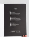 Composition Book in Black on a themed background