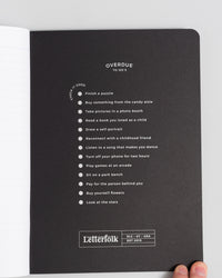 Composition Book in Black on a themed background