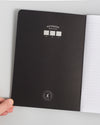 Composition Book in Black on a themed background