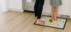 A woman and child standing on a Letterfolk tile mat in the Kitchen. 