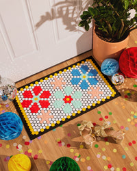 The Letterfolk Tile & Mat Set Advance Bundle designed on a Tile Mat in front of a doorway. 