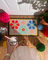 Top view of the Letterfolk Tile & Mat Set Advance Bundle designed on a Tile Mat in front of a doorway. 