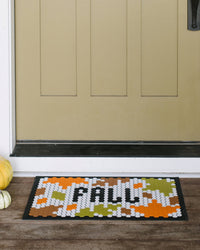 The Letterfolk Harvest Tile Set on a Tile Mat Design placed on a wooden porch. 