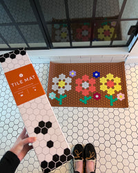 An image displaying the packaging and a made up Letterfolk Clay Tile Mat. 