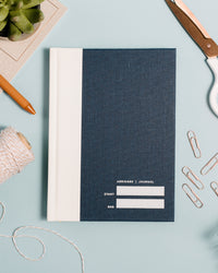 Abridged Journal in Navy on a themed background