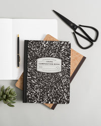 Composition Book in Black on a themed background