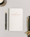 Ruled Everyday Notebook on a themed background