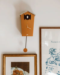 Kookoo Clock in Copper hanging on the wall