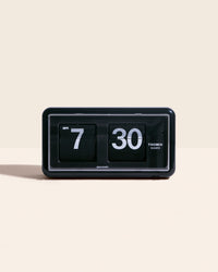 Midcentury Flip Clock in Black on a cream background