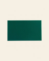 The Letterfolk Standard Green Tile Mat on a cream background. 